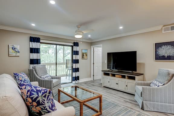 Fully updated condo with serene view, enclosed balcony, WiFi, W/D, pool, & gym